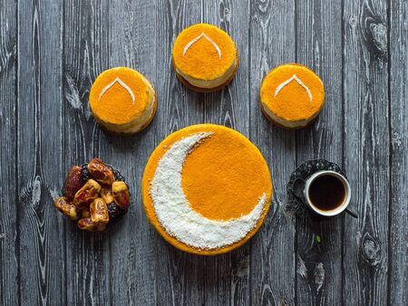 Homemade golden cake with a Crescent moon, served with black coffee and dates. Ramadan background,の写真素材