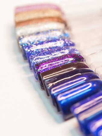 Palette with nail designs of different colors with gel polish, soft focus, close up.の写真素材