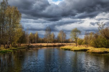 Russian spring landscape with reflections of trees in the lake.の写真素材