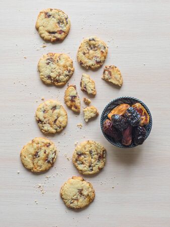 Fresh juicy date cookies it is laid out on a light wooden surface. Top view.の写真素材
