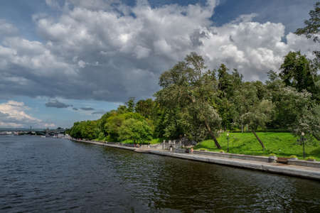 The embankment of the Moscow river. A shady green embankment along a wide river.の写真素材