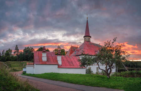 Wonderful evening sunny landscape. Incredible majestic Priory Palace in Gatchina. Amazing natural background. Panoramic view.の写真素材