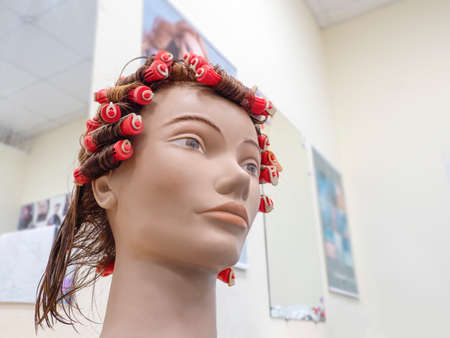 Perm training on a mannequin at the school of hairdressing.の写真素材