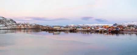 An old rusty fishing boat washed up on a sandy beach in the Barents Sea. Authentic the North sea. Teriberka.の写真素材