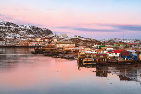 Small authentic village on the White sea coast. Authentic Russian northern village, old wooden houses. Kashkarantsy fishing collective farm. Kola Peninsula. Russia.の写真素材
