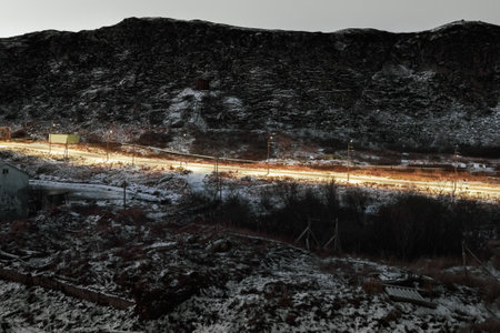 Cross on the Kola Peninsula, cold dawn in Teriberka. Balancing Rock on the Arctic hill. Amazing of...