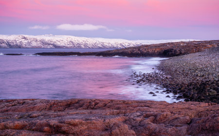 The texture of the sand on the sea beach at low tide at sunset. The Barents Sea.
