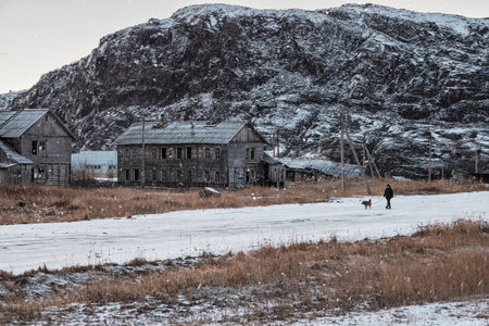 Russia, Teriberka, November, 30 2020. The car is parked on a hill in the arctic tundra. Travel concept of traveling by car. Slippery Arctic road through the hills. Winter Teriberka.のeditorial素材