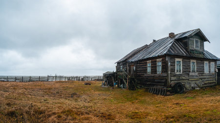 A wooden chapel built for the filming of the film. Snowy winter landscape with authentic cinematic house on the shore in the Russian village Rabocheostrovsk.のeditorial素材