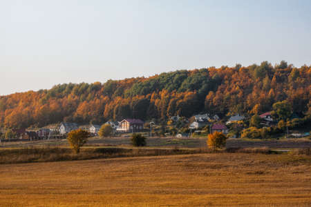 Panoramic view of green grass on slope with blue sky.の写真素材