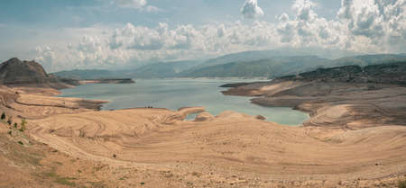 Beautiful futuristic views of the canyon and reservoir, travel concept. Cars on the beach. Remote...