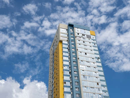 Modern beautiful new buildings. Colored wall on the background of blue sky.