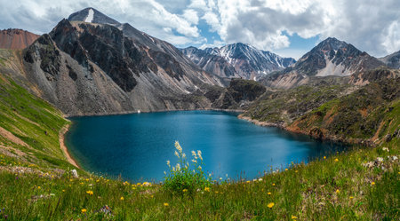 Beautiful panoramic mountain landscape with red snow rocks. Big rock formation, different rock formations and soil layers. Distant mountain plateau.の写真素材