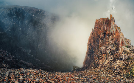 Beautiful panoramic mountain landscape with red snow rocks. Big rock formation, different rock formations and soil layers. Distant mountain plateau.の写真素材