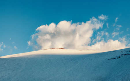 Snow mountain dome. Big snowy mountain. The top of the mountain Dome of three lakes. Altai mountains. Panoramic view.の写真素材