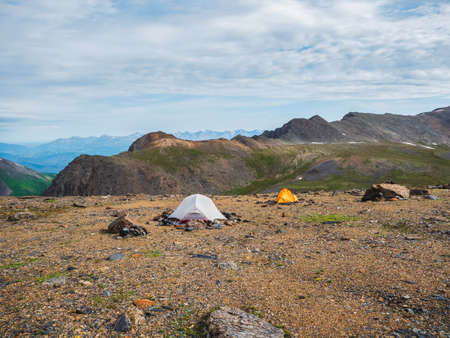 Wonderful dramatic landscape with big snowy mountain peaks above low clouds. Atmospheric large snow mountain tops in cloudy sky.の写真素材