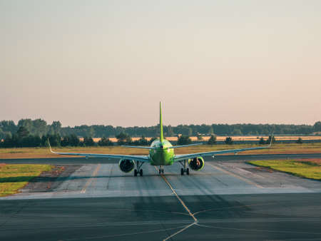 The plane before takeoff. White plane is on takeoff in the morning. Copy space.の写真素材