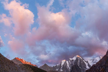 Tourist complex, wooden guest house against the background of snow-covered high mountains.の写真素材