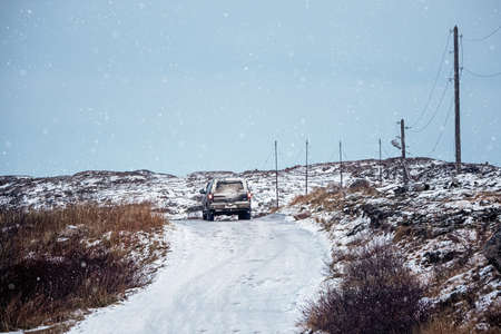 Slippery Arctic road through the hills. Drop-off of tourists. Winter Teriberka. Russia.の写真素材