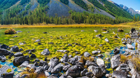 Blue mountain lake in the caldera. Mountain range against a blue cloudy sky. Caldera of an extinct...