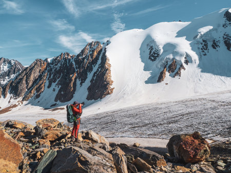 Portrait of a happy travel photographer with a large camera on his hands. Travel freelancer blogger lifestyle, concept adventure voyage outdoor.の写真素材