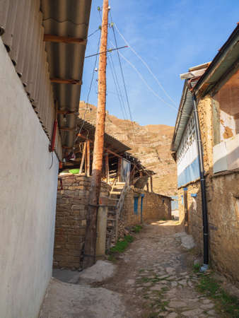 Narrow alleys of a mountain village. Rural clay and stone houses in a village in Kakhib. Old mountain village in Dagestan. Vertical viewの写真素材