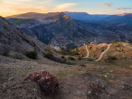 Authentic city under the rock with serpentine dirt road. Vintage Dagestani mountain village of Gunib...