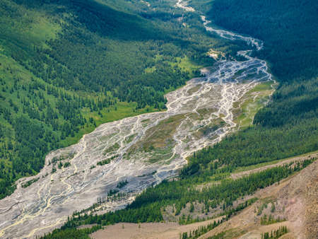 Glaciers melt, water flows into the valley. Picturesque highland green landscape with wide mountain...