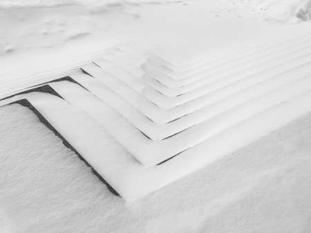 Monochrome texture of white snow. Abstract winter background with sunlight on snow.の写真素材