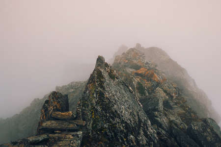 Mountain peaks under a blue sky natural background. Wonderful clear landscape with big snowy mountain peaks on a distance. Atmospheric large snow mountain tops in blue sky.の写真素材