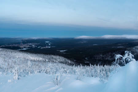 Snow-covered polar cone hill in winter early in the morning. winter polaris landscape. View of the snow-covered tundra and hills. Cold winter weather. Harsh northern climate. square view.の写真素材