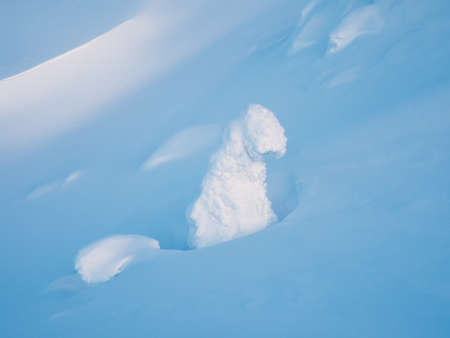 Amazing cold pink dawn over a snowy winter hill. View of the snow-covered tundra and hills. Arctic...
