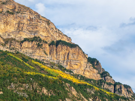 Beautiful mountain landscape with red rounded rocks. Big rock formation, different rock formations and soil layers. Distant mountain plateau. North Ossetia.の写真素材