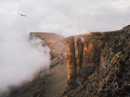 soft focus. Bermamyt plateau. Foggy mountain view from cliff at very high altitude. Scenic alpine landscape with beautiful sharp rocks at sunrise. Beautiful scenery on abyss edge with sharp stones.の写真素材