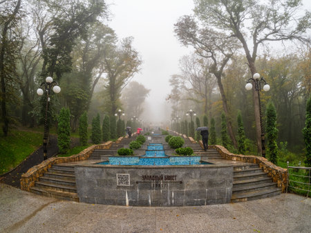 Zheleznovodsk, Russia - October, 2022: Beautiful old stone staircase in the autumn misty park....