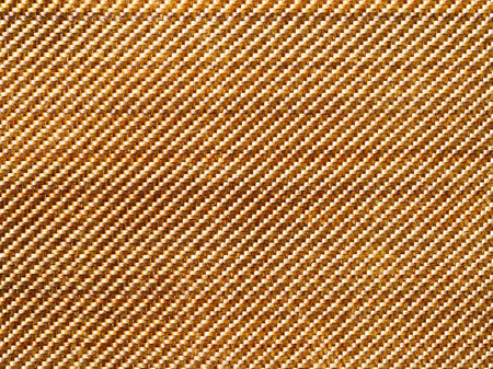 Bulletproof material aramid. Aramid kevlar background. Golden kevlar texture and pattern.