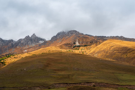 soft focus. Mountains in a dense fog. Mystical landscape with beautiful caucasian mountains in low...
