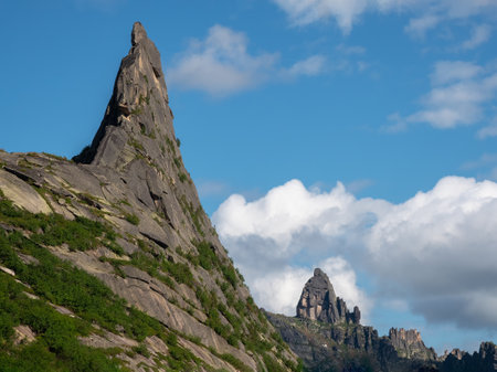 Pointed cliff, a misty mountainside. Ghost rocks. Awesome scenic mountain landscape with big cracked pointed stones closeup in misty morning. Sharp rocks background. Western Sayansの写真素材