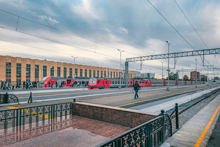 Saint-Petersburg, Russia - September, 20, 2023: Platform with trains at the Baltic Railway Station in the morning. Cloudy autumn day at the railway station. Passengers walk along the platform.のeditorial素材