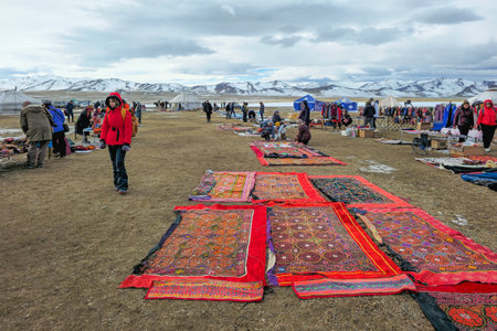 Ulgiy, Mongolia - October, 01, 2023: Sale of homemade bags, cap and carpets with traditional ornaments. Handmade knitted bags. Kazakh outdoor market. Travel to the Mongolia.のeditorial素材
