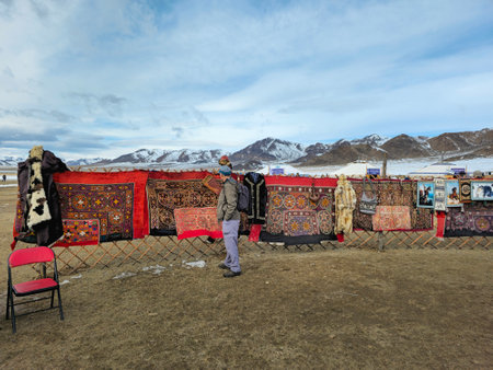 Ulgiy, Mongolia - October, 01, 2023: Sale of homemade bags, cap and carpets with traditional ornaments. Handmade knitted bags. Kazakh outdoor market. Travel to the Mongolia.のeditorial素材