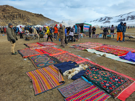 Ulgiy, Mongolia - October, 01, 2023: Sale of homemade bags, cap and carpets with traditional ornaments. Handmade knitted bags. Kazakh outdoor market. Travel to the Mongolia.のeditorial素材