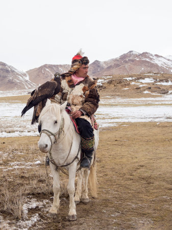 Ulgii, Mongolia - October, 01, 2023: Northern Mongolia. Portrait of a male hunter with a hunting...