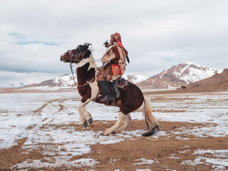 Ulgii, Mongolia - October, 01, 2023: Northern Mongolia. Portrait of a male hunter on horseback with...