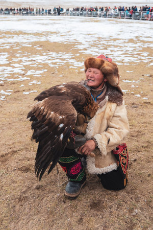 Ulgii, Mongolia - October, 01, 2023: Northern Mongolia. Portrait of a male hunter with a hunting...