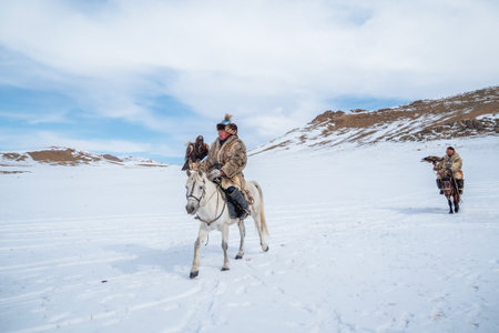 Ulgii, Mongolia - October, 01, 2023: Portrait of a male hunter on horseback with a hunting golden eagle. Eagle hunters are individuals who train and hunt with golden eagles. Northern Mongolia.のeditorial素材