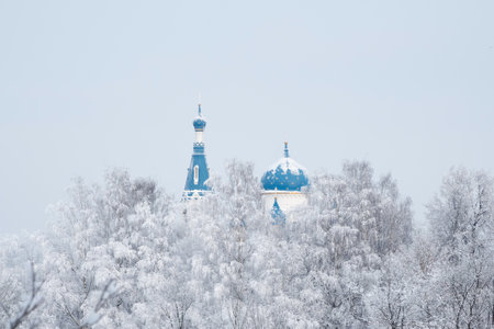 Christian temple with blue houses. Ancient Christian temple in winter day. St. Basil's Cathedral in the historic center of Gatchina. Russia.の写真素材