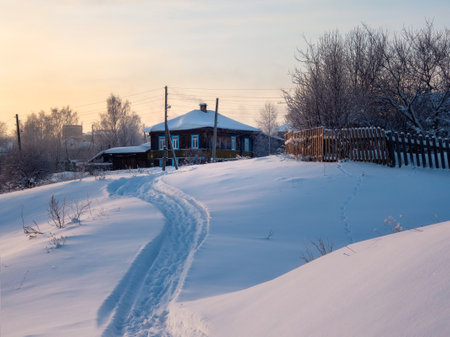 Path to the wooden house. Frozen winter village, a trail through snowdrifts and a lot of snow. Impressive winter rustic view. Siberia, Russia.の写真素材