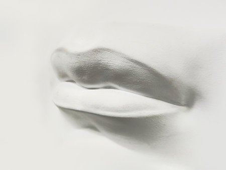Gypsum human mouth close-up on light background. Plaster face, sculpture, mask.の写真素材