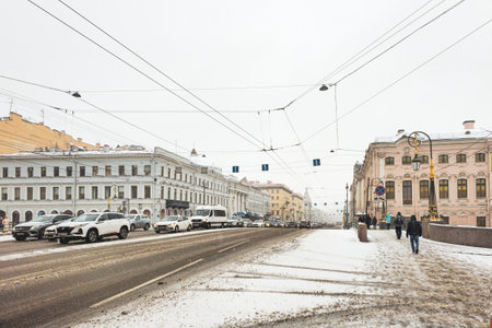 Saint Petersburg, Russia - April 19, 2024: Traffic jam from cars. Winter urban landscape. People walk through the city center during heavy snowfall and blizzard. Storm warning, urban life.のeditorial素材